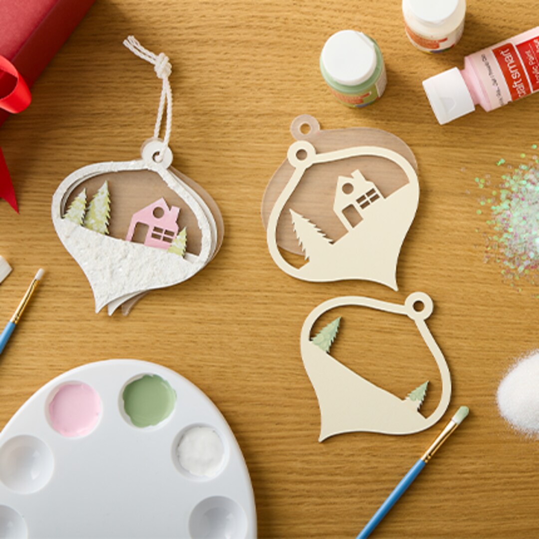 Christmas DIY Ornaments Showing Two Wood Ornaments Being Painted christmas-diy-ornaments-showing-two-wood-ornaments-being-painted